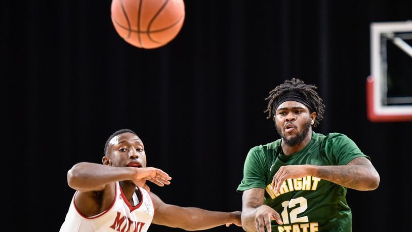 Wright State’s Tye Wilburn makes a pass as he is defended by Miami’s Isaiah Coleman-Lands during their game Tuesday, Nov. 14 at Millett Hall on the Miami University Campus in Oxford. NICK GRAHAM/STAFF