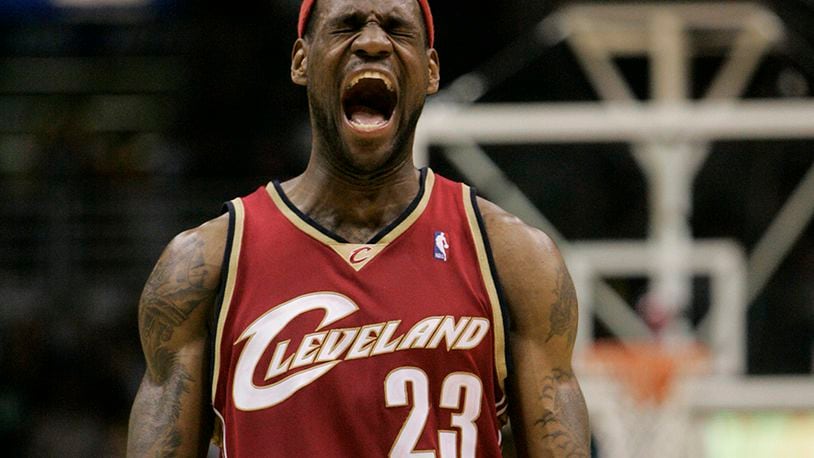 FILE - In this March 10, 2007, file photo, Cleveland Cavaliers forward LeBron James reacts to a shot made by teammate Anderson Varejao during the final seconds of the fourth quarter of an NBA basketball game in Milwaukee. James told Sports Illustrated on Friday, July 11, 2014, he is leaving the Miami Heat to go back to the Cleveland Cavaliers. (AP Photo/Morry Gash, File)