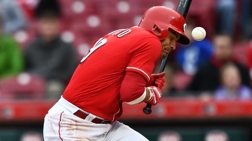 CINCINNATI, OH - APRIL 1:  Joey Votto #19 of the Cincinnati Reds is hit by a pitch to load the bases in the eighth inning against the Washington Nationals at Great American Ball Park on April 1, 2018 in Cincinnati, Ohio. Washington defeated Cincinnati 6-5.  (Photo by Jamie Sabau/Getty Images)
