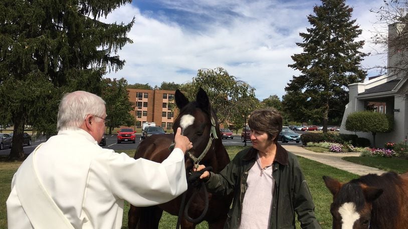 Two horses were among the animals, including humans, who received blessings at Human Family Church in Middletown on Sunday. The Rev. John Lyons, a deacon, performed the ceremony. MIKE RUTLEDGE/STAFF