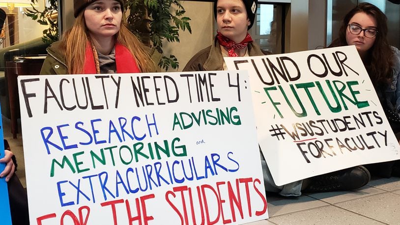 Wright State University students protest Thursday outside President Cheryl Schroeder’s office.