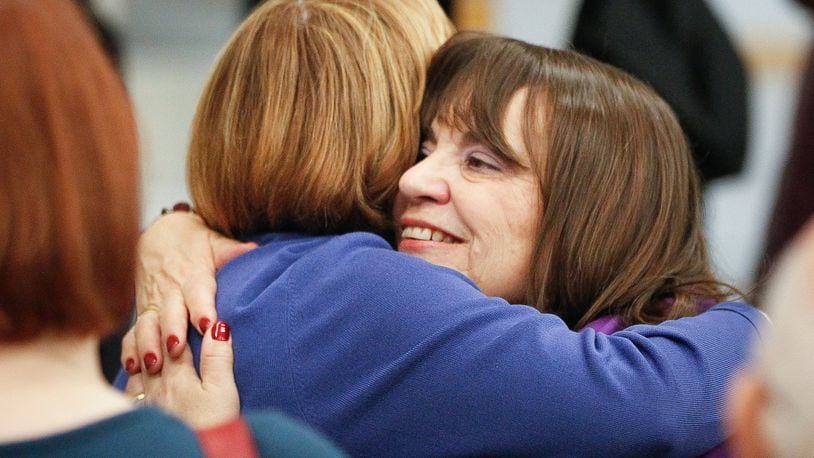 Carolyn Rice, who was sworn in as a Montgomery County commissioner on Wednesday, is hugged by fellow County Commissioner Judy Dodge. Rice’s election in November makes the board all female for the first time in county history. CHRIS STEWART / STAFF