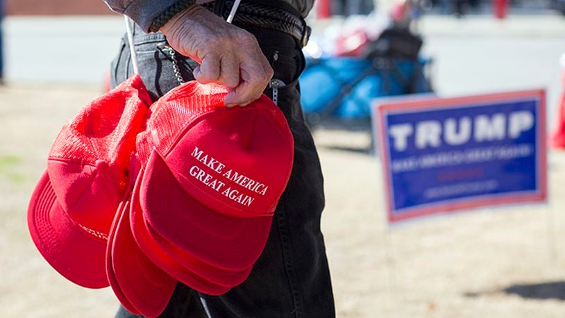 A vendor sells "Make America Great Again" hats for before a rally for then-candidate Donald Trump, in North Augusta, S.C., Feb. 16, 2016. Clothing of late at fashion shows, and now awards shows, frequently includes social or political messaging, a trend that has picked up steam since the U.S. presidential campaign.