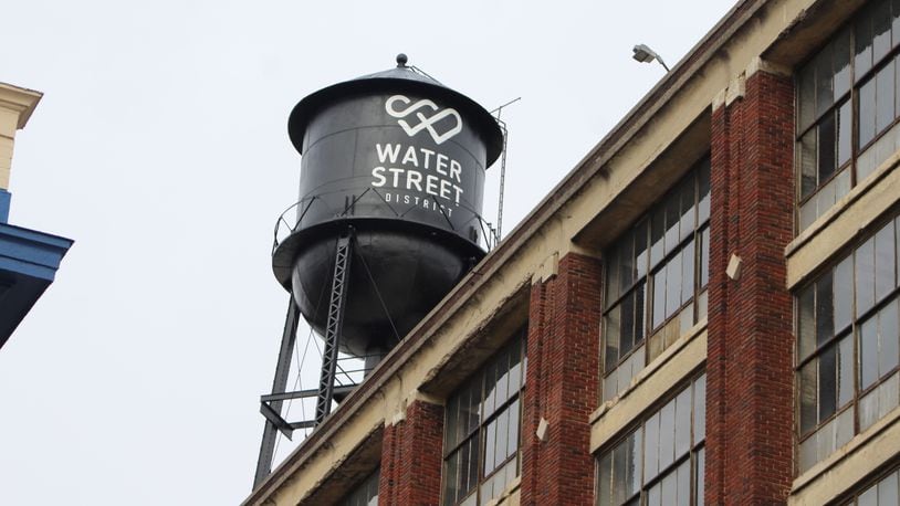 The water tower atop the massive Mendelsons outlet building has been painted to say the Water Street District. The developers plan to turn the building into apartments, offices, retail and other uses. CORNELIUS FROLIK / STAFF