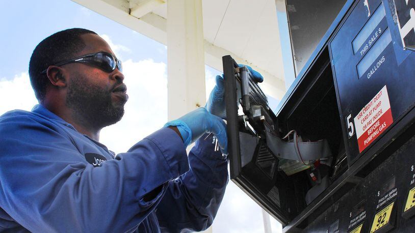 Joseph Harris, chief inspector with the Montgomery County Auditor office’s weights and measures division, checks a gas pump for skimmers at Clark gas station on Old Troy Pike. CORNELIUS FROLIK / STAFF