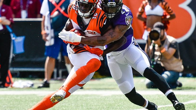 Cincinnati Bengals’ wide receiver A.J. Green is tackled by Baltimore Ravens’ cornerback Jimmy Smith during their game Sunday, Sept. 10 at Paul Brown Stadium in Cincinnati. NICK GRAHAM/STAFF