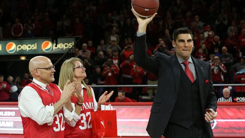 Miami University president Dr. Gregory Crawford and his wife, Dr. Renate Crawford, applaud as Wally Szczerbiak, the greatest player in school history, acknowledges the crowd at halftime of Miami’s game Friday night in Oxford. PHOTO COURTESY OF MIAMI UNIVERSITY
