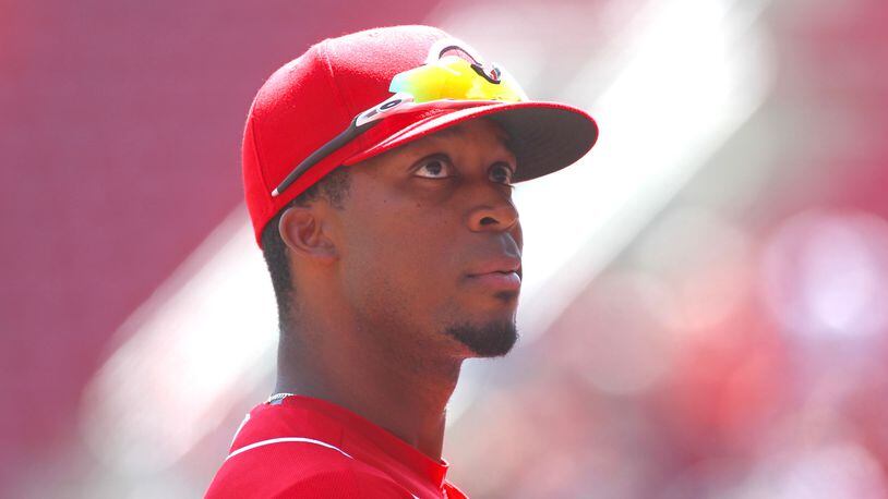Rosell Herrera watches the action from the Reds dugout during a game against the Braves on Thursday, April 26, 2018, at Great American Ball Park in Cincinnati. David Jablonski/Staff