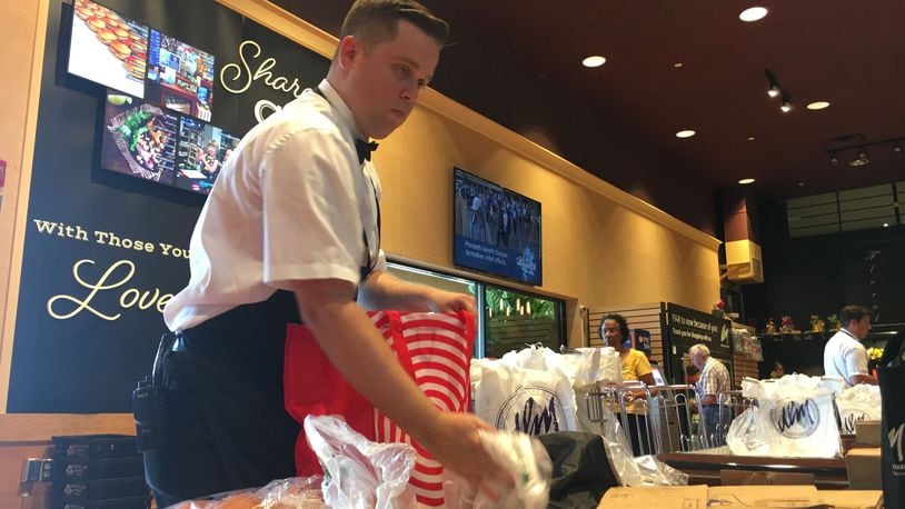 Connor Yoakum, 21, bags groceries at the Dorothy Lane Market store at Washington Square. He will compete at the Ohio Grocery Association’s best bagger competition Tuesday. STAFF PHOTO / HOLLY SHIVELY