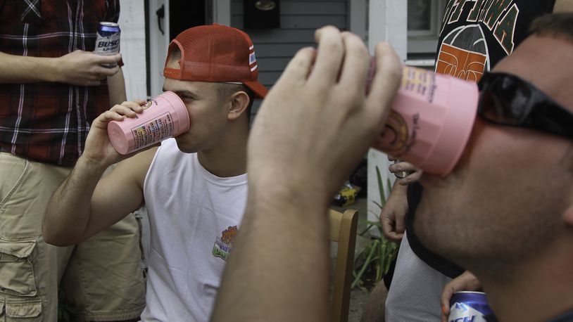 University of Dayton students play drinking games in front of a house in the UD student neighborhood. CHRIS STEWART / STAFF