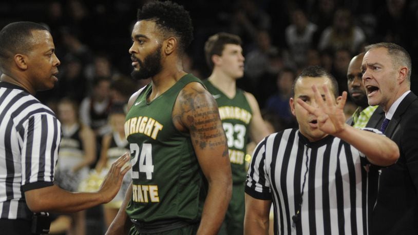 Referee Edwin Young (left), a former University of Dayton standout, addresses a foul with Mark Alstork of Wright State while Raiders coach Scott Nagy (right) also has a say. WSU played at Oakland (Mich.) in a Horizon League opener on Thursday, Dec. 29, 2016. MARC PENDLETON / STAFF