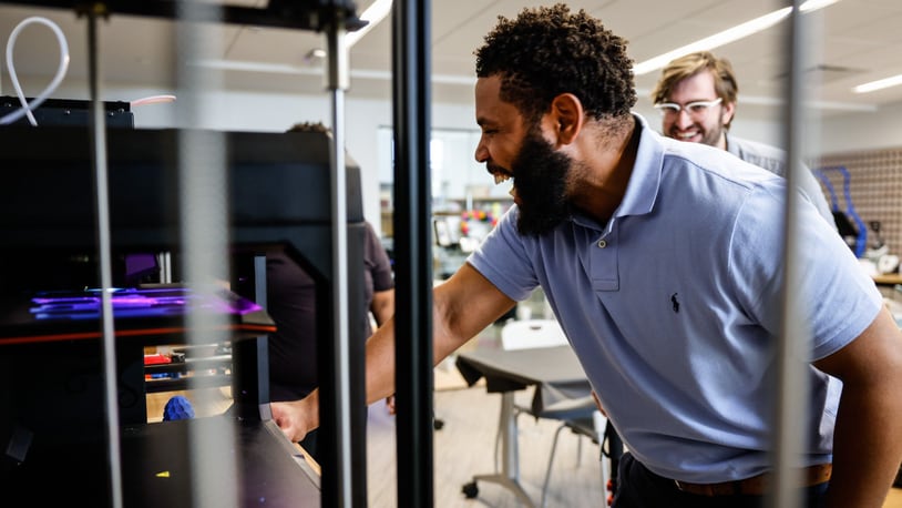Lead for the Outreach Committee Westside Makerspace, Dr. Marcus Smith operates a 3D printer at the West Dayton Library Makerspace on Friday May 19, 2022. The makerspace has been approved for a $1 million grant from the city of Dayton. JIM NOELKER/STAFF