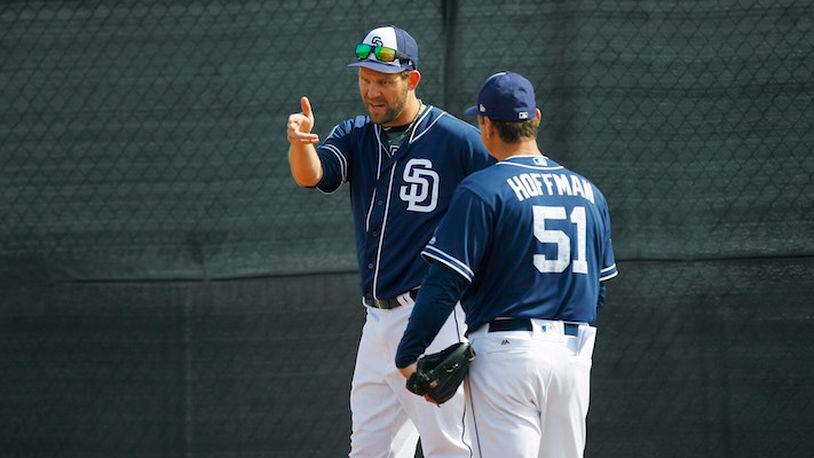 San Diego Padres pitcher Tom Wilhelmsen, who became a bartender during his seven seasons away from baseball, works with Trevor Hoffman (51) during a spring training practice in Peoria, Ariz., on February 21, 2018. (K.C. Alfred/San Diego Union-Tribune)