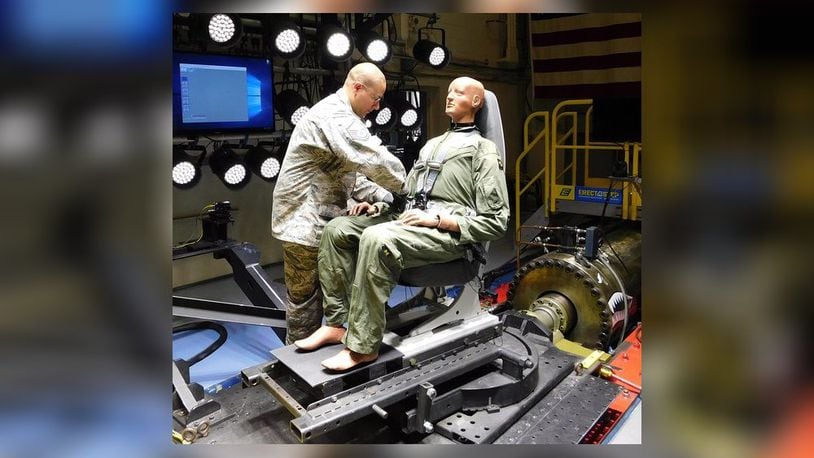 Master Sgt. James Chase of Air Force Research Laboratory’s 711th Human Performance Wing Biodynamics team prepares an instrumented 250-pound test device, simulating a human occupant, for seat testing on the Horizontal Impulse Accelerator, located at Wright-Patterson Air Force Base. The test is one of a series recently conducted to support the acceptance and implementation of the Portable Biocontainment Care Module, which will aid in the safe transport of personnel affected by infectious diseases, including COVID-19. (Courtesy photo/Infoscitex Corp., Christopher Albery)
