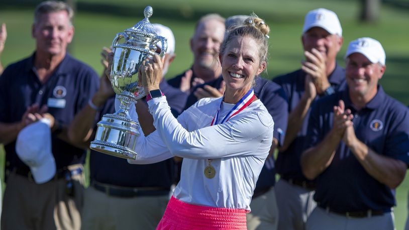Jill McGill holds her trophy after winning the U.S. Senior Women's Open golf tournament at NCR Country Club in Kettering, Sunday, Aug. 28, 2022. It was the first professional win of her career. Jeff Gilbert/Dayton Daily News