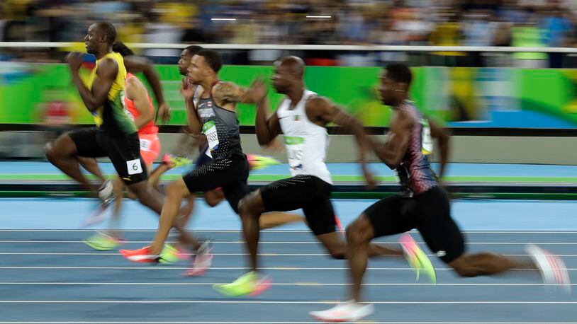 Jamaica's Usain Bolt, left, takes the lead in a men's 100-meter semifinal during the athletics competitions of the 2016 Summer Olympics at the Olympic stadium in Rio de Janeiro, Brazil, Sunday, Aug. 14, 2016. (AP Photo/Matt Dunham)