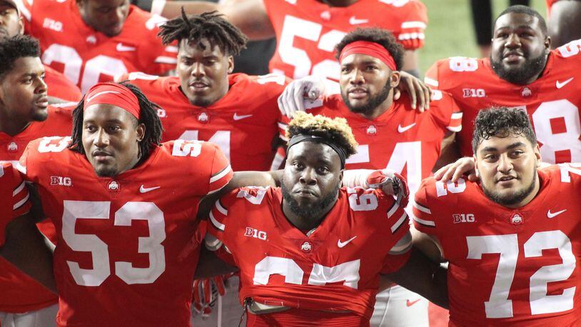 Ohio State players, including Robert Landers, center, sing “Carmen Ohio” after a victory against Indiana on Saturday, Oct. 6, 2018, at Ohio Stadium in Columbus. David Jablonski/Staff