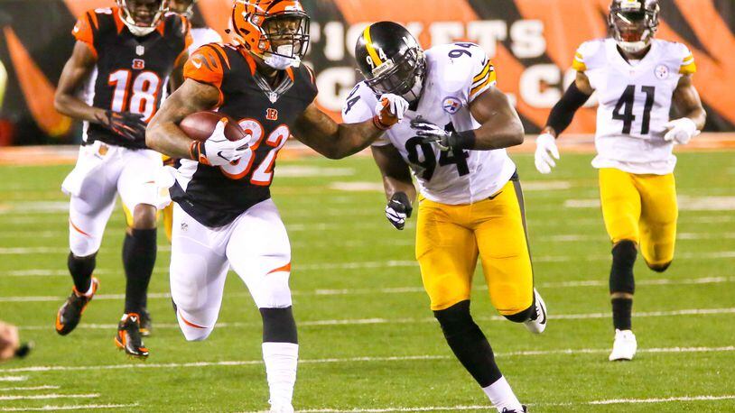 Cincinnati running back Jeremy Hill (32) looks for yards along the sidelines during their wild card playoff game at Paul Brown Stadium in Cincinnati, Saturday, Jan. 9, 2016. GREG LYNCH / STAFF