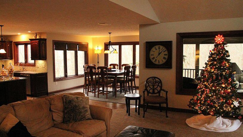 Windows surround the breakfast room on 3 sides to take in the wooded view, and sliding glass doors open to the screened porch.