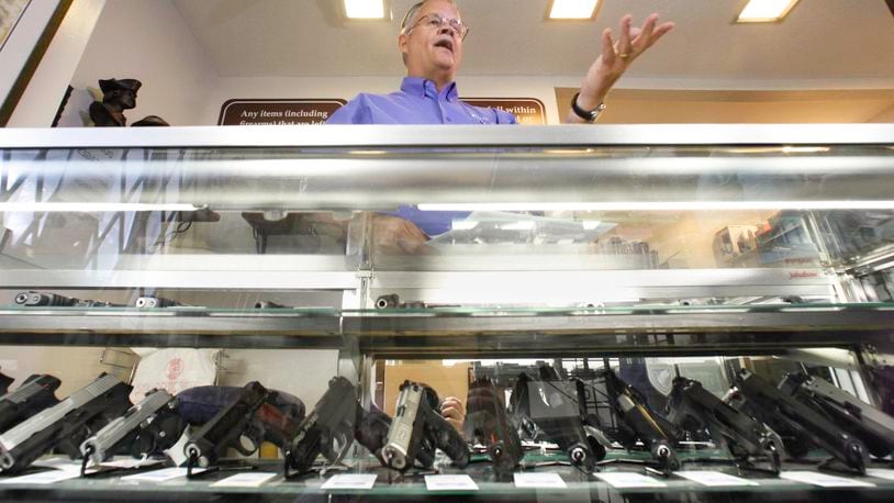 John Thyne, owner of Peabody Sports in Clearcreek Twp., Warren County, is a federally licensed dealer. Here, he discusses gun background checks and internet sales of firearms. CHRIS STEWART / STAFF