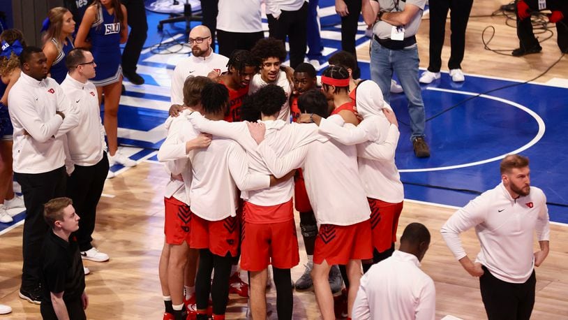 Dayton huddles before a game against Saint Louis on Friday, March 3, 2023, at Chaifetz Arena in St. Louis, Mo. David Jablonski/Staff