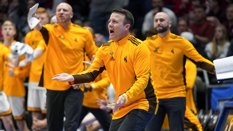 Wyoming hcoach Jeff Linder, center, reacts to a technical foul during the first half of the team's First Four game against Indiana in the NCAA men's college basketball tournament Tuesday, March 15, 2022, in Dayton, Ohio. (AP Photo/Jeff Dean)
