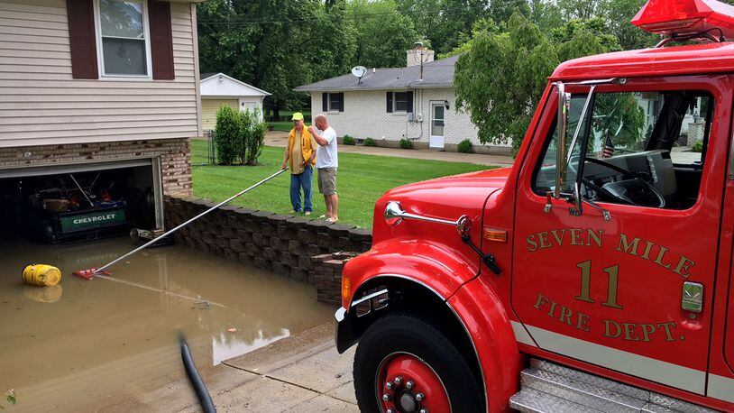 The Seven Mile Fire Department in Butler County was busy Thursday morning pumping water out of homes on Taylor School Road. NICK GRAHAM/STAFF
