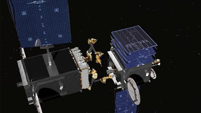 This artistâ€™s rendering shows the robotic arms that are being built for DARPAâ€™s RSGS program. The robotic servicer, on the left, is preparing to use a tool to open a stuck solar array on a disabled satellite. (SSL)