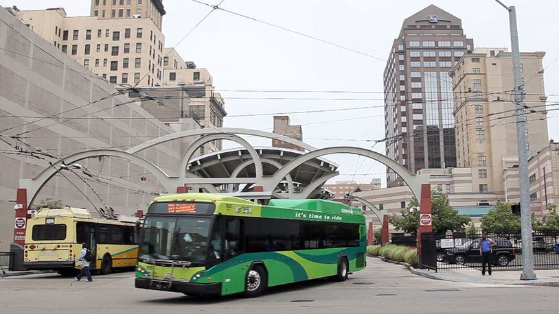 Tthe RTA is expected to cut some routes and raise prices to cope with the loss of $4.6 million in sales tax revenue in 2018. RTA buses are shown at the Wright Stop Plaza in downtown Dayton. TY GREENLEES / STAFF