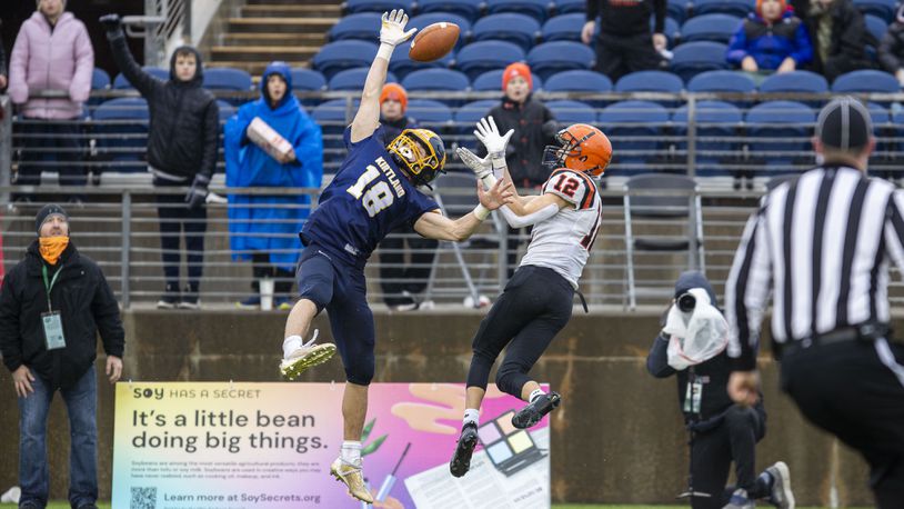 Versailles junior Jace Watren and Kirtland sophomore Will Beers fight for a pass during the Division VI state championship game against Kirtland on Friday morning at Tom Benson Hall of Fame Stadium in Canton. MIchael Cooper/CONTRIBUTED