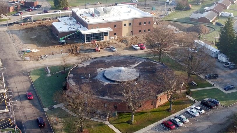 Greene County’s new Public Health Building, seen here in April 2018 in the final stages of construction on the campus of Greene Memorial Hospital in Xenia. The new building is located next to the current, round shaped, Public Health Building, foreground, which will be demolished after employees move into the new building. TY GREENLEES / STAFF