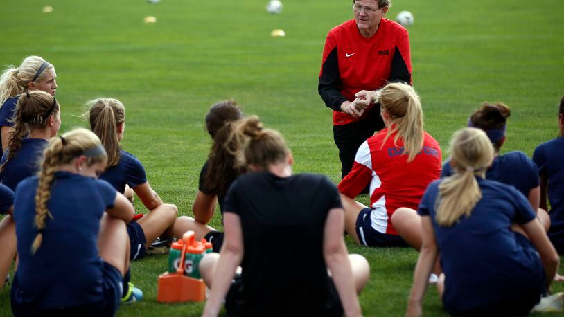 University of Dayton soccer player Sidney LeRoy is front and center with coach and grandfather Mike Tucker during a practice in 2015. TY GREENLEES / STAFF