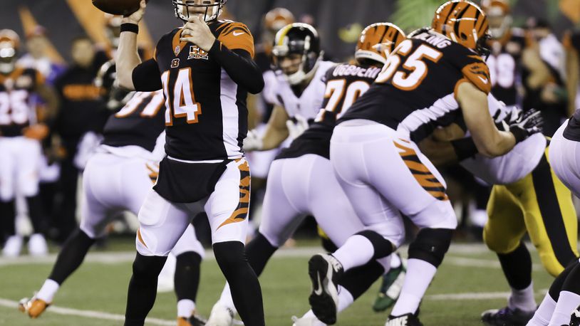 Bengals quarterback Andy Dalton (14) looks for an open receiver during the first quarter of their game against the Steelers, at Paul Brown Stadium, Monday, Dec. 4, 2017. GREG LYNCH / STAFF