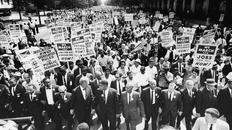 Civil rights leaders hold hands as they lead a crowd of hundreds of thousands at the March on Washington for Jobs and Freedom, Washington DC, August 28, 1963.