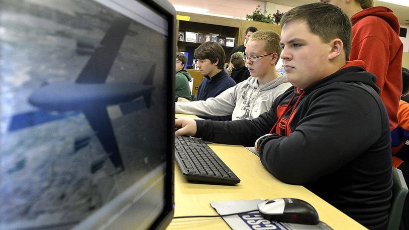 Greenon High School STEM student, Tyler Johnson, right, and his classmates work with UAS software in their class Wednesday. The STEM students are using software from Analytical Graphics Inc. to take part in a class on drones. Students will use the drone software and perform tasks like mapping out the data from a natural disaster and creating a safe evacuation plan. Bill Lackey/Staff