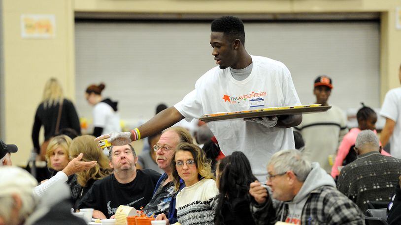 Sinclair men’s basketball player, Javell, serving at Dayton Convention Center for the 2017 Feast of Giving. Photo by Leon Chuck