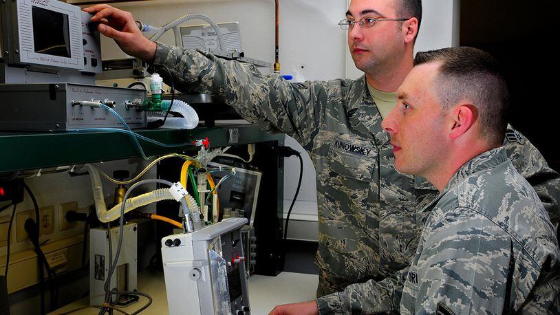 Senior Airman Eric Rinehart and Senior Airman Scott Kunowsky, 86th Medical Support Squadron, calibrate a 754M Uni-Vent ventilator, Ramstein Air Base, Germany, March 28. The device generates oxygen to support patients who require assisted ventilation. (U.S. Air Force photo/Airman 1st Class Brea Miller)