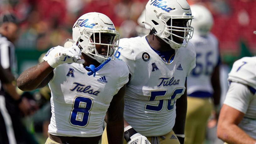 Tulsa running back Deneric Prince (8) celebrates his touchdown against South Florida with offensive lineman Tyler Smith during the first half of an NCAA college football game Saturday, Oct. 16, 2021, in Tampa, Fla. (AP Photo/Chris O'Meara)