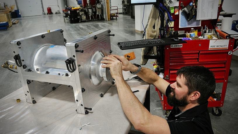 Spintech employee Abe McNutt, works on one of the parts that the company manufactures at their new facility in Miamisburg. MARSHALL GORBY\STAFF