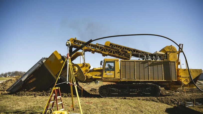 A DeWind construction worker uses the trencher Nov. 21 to dig a 30-foot-deep trench at Wright-Patterson Air Force Base. The trencher digs, lays the pipe and fills the trench in one efficient and environmentally friendly pass. (U.S. Air Force photo by Hannah Carranza)