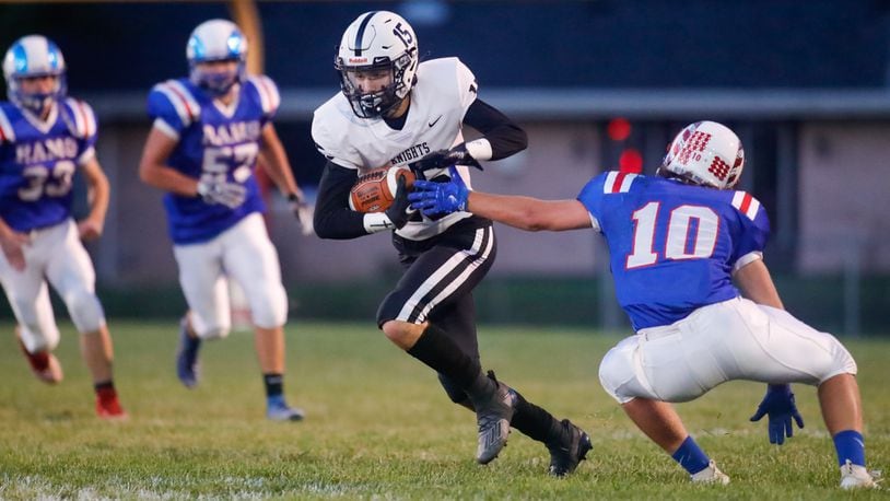 Greenon High School senior wide receiver Clay Hough runs past Greeneview's Caleb Allen during their game on Friday night at Don Nock Field in Jamestown. The Knights won 21-20 to win their second straight Ohio Heritage Confernece South Division championship. CONTRIBUTED PHOTO BY MICHAEL COOPER