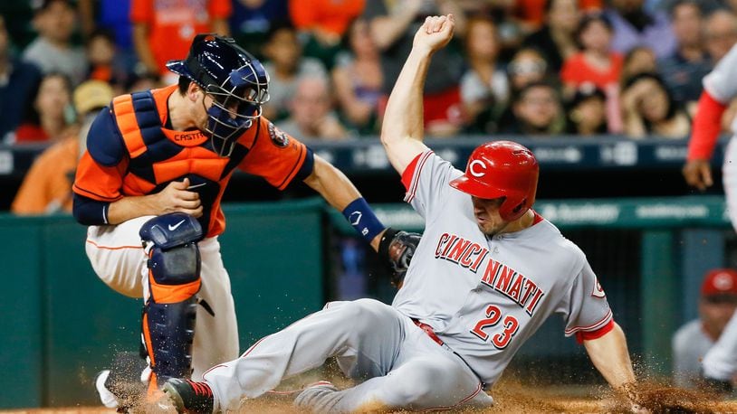HOUSTON, TX - JUNE 17:  Adam Duvall #23 of the Cincinnati Reds scores on a double by Eugenio Suarez in the eleventh inning as Jason Castro #15 of the Houston Astros is late with the tag  at Minute Maid Park on June 17, 2016 in Houston, Texas.  (Photo by Bob Levey/Getty Images)