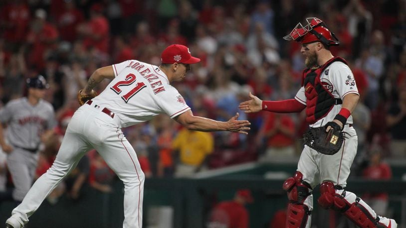 Reds reliever Michael Lorenzen, left, and catcher Tucker Barnhart celebrate after the final out of a victory against the Astros on Tuesday, June 18, 2019, at Great American Ball Park in Cincinnati. David Jablonski/Staff