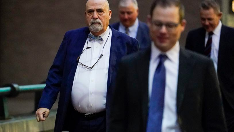 Defense attorney Mark Marein, left, walks toward Potter Stewart U.S. Courthouse before jury selection in the federal trial of former Ohio House Speaker Larry Householder, Friday, Jan. 20, 2023, in Cincinnati. Householder and former Ohio Republican Party chair Matt Borges are charged with racketeering in an alleged $60 million scheme to pass state legislation to secure a $1 billion bailout for two nuclear power plants owned by Akron, Ohio-based FirstEnergy. Householder and Borges have both pleaded not guilty. (AP Photo/Joshua A. Bickel)