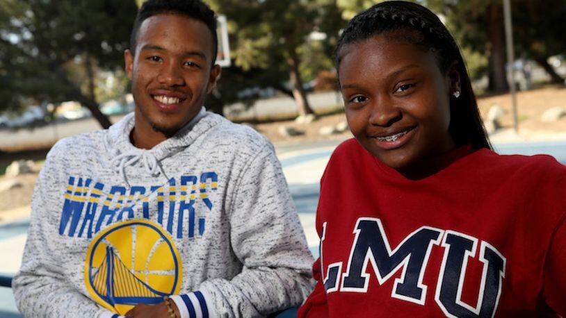 Boys and Girls Club of the Peninsula 2018 Youth of the Year recipients Alysia Demery, 17, and Dezmond Fraiser, 17, from left, pose for a photograph in front of the basketball court donated by Golden State Warriors forward Kevin Durant in Redwood City, Calif., on Friday, April 27, 2018. Durant recently announced he will help pay a portion of both Demery and Fraiser's college education. (Anda Chu/Bay Area News Group/TNS)