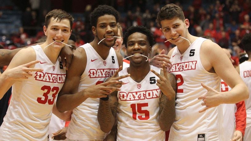 Dayton sophomores Ryan Mikesell, Xeyrius Williams, John Crosby and Sam Miller pose for a photo after a victory against Virginia Commonwealth on Wednesday, March 1, 2017, at UD Arena. David Jablonski/Staff