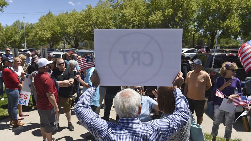 FILE - A man holds up a sign against Critical Race Theory during a protest outside a Washoe County School District board meeting on May 25, 2021, in Reno, Nev. Critical race theory has become a lightning rod for Republicans and an issue in some Election Day races around the country. (Andy Barron/The Reno Gazette-Journal via AP, File)