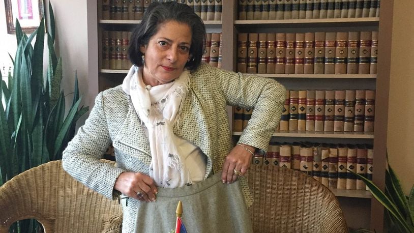 Isabel Suarez, a Dayton attorney, holding up the skirt her mother brought over from Cuba. CONTRIBUTED