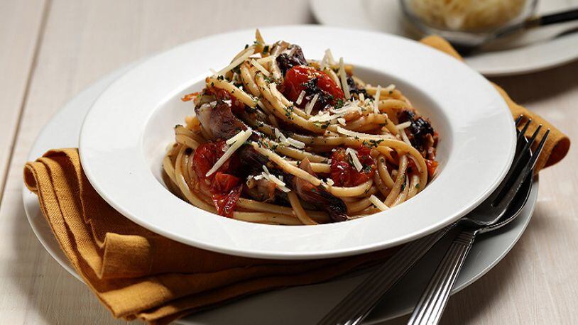 Long strands of bucatini, the pasta with a hole down the middle, are tossed with roasted tomatoes, radicchio and garlic. Styled by Mark Graham.   (E. Jason Wambsgans/Chicago Tribune/TNS)