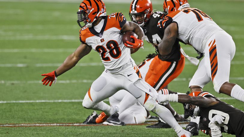 Cincinnati Bengals running back Joe Mixon (28) breaks free from Cleveland Browns cornerback Terrance Mitchell (39) during the first half of an NFL football game, Thursday, Sept. 17, 2020, in Cleveland. (AP Photo/Ron Schwane)